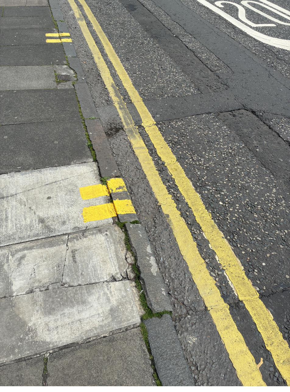 Edinburgh double yellow lines on road with double yellow kerb marks showing no waiting and no loading at any time
